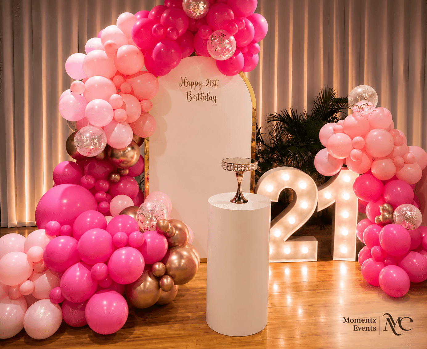 21st birthday backdrop with a pink and rose gold balloon garland, styled by Momentz Events